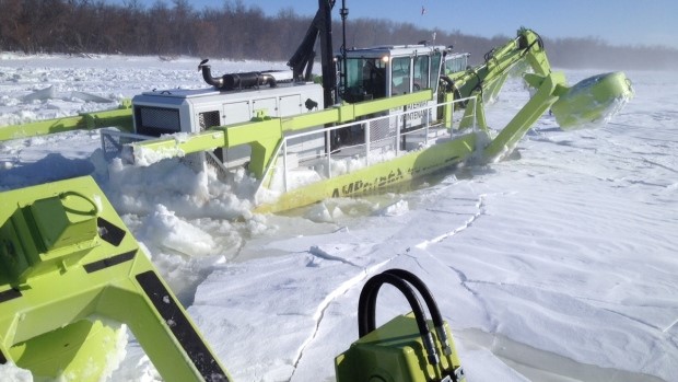 Amphibex dredge-excavator and ice breaking machine at work in Manitoba, breaking up River ice to reduce potential for ice jams and flooding. Source: CBC