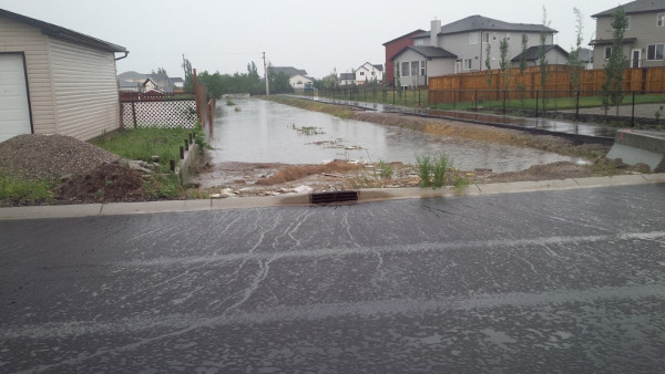 Figure 3: Langdon Stormwater Conveyance overflowing onto private property.