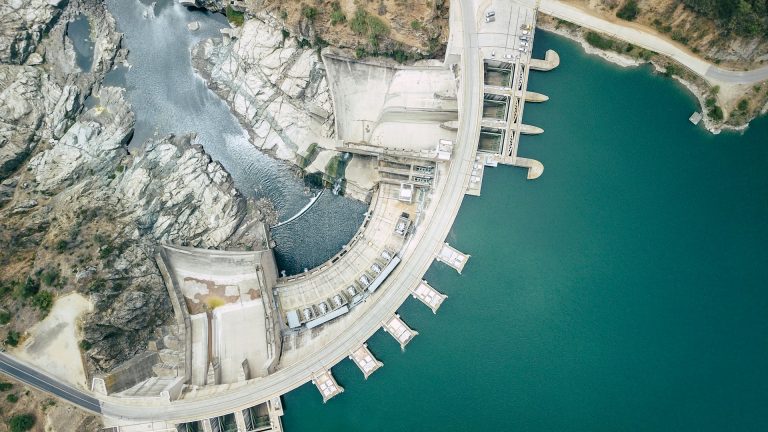 Overhead view of an arch dam and reservoir