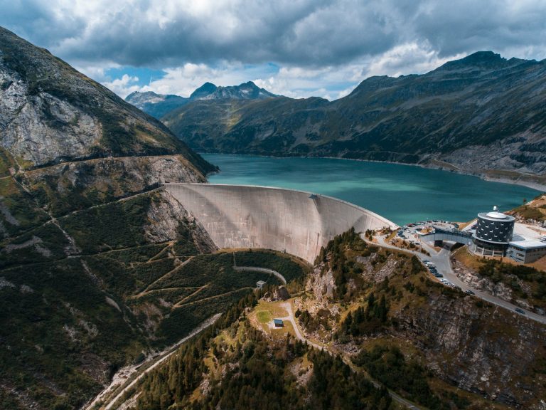 Looking upstream at a dam wall and the full reservoir behind it.