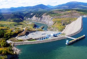 Photograph of the WAC Bennett dam looking over the dam wall at the electricity substation at the base of the wall