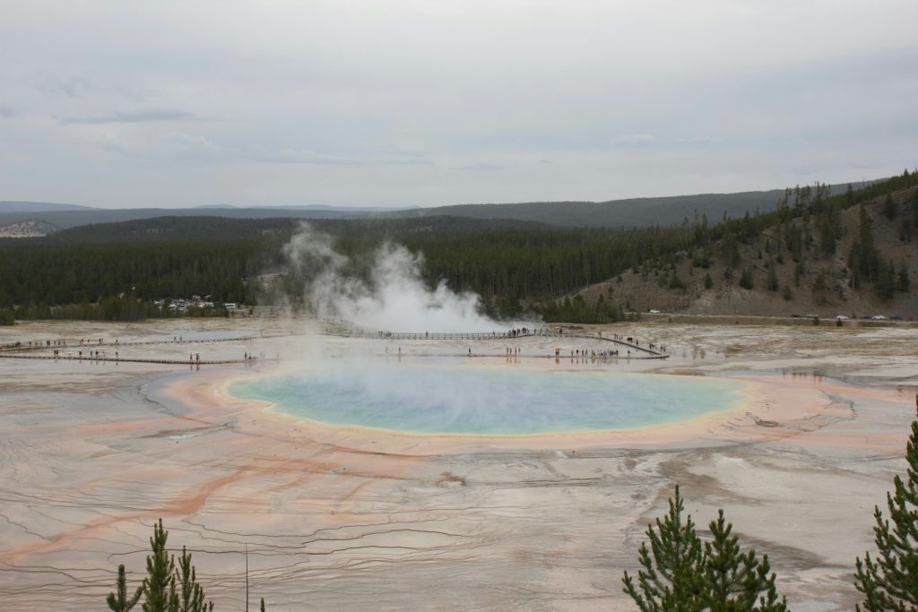 A photograph of a hot spring with steam rising.