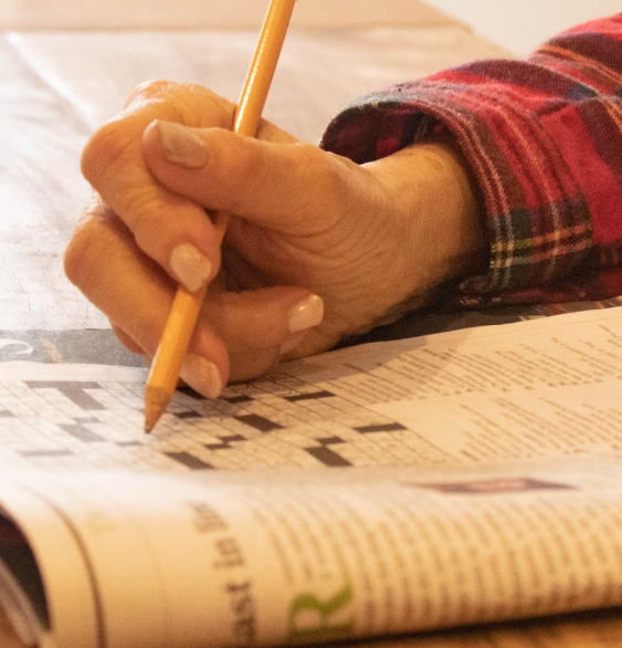 Person completing a crossword