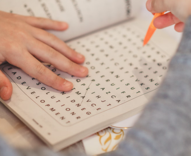 child doing a crossword, image