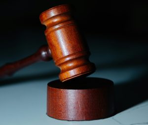 wooden gavel sitting on top of a white counter